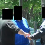 A group of people standing around each other.