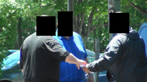 A group of people standing around each other.