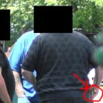 A man is seen in the back of another man 's head.