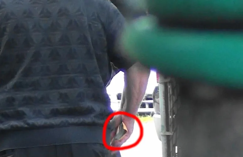 A man with a red circle around his finger.