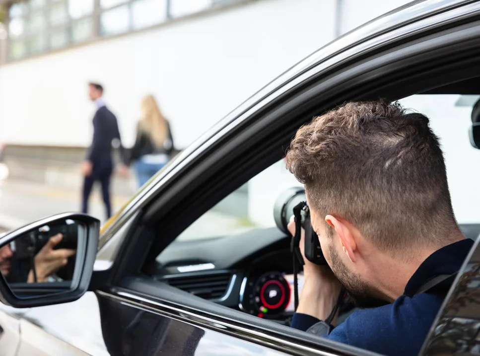 A man taking a picture of some people in the street