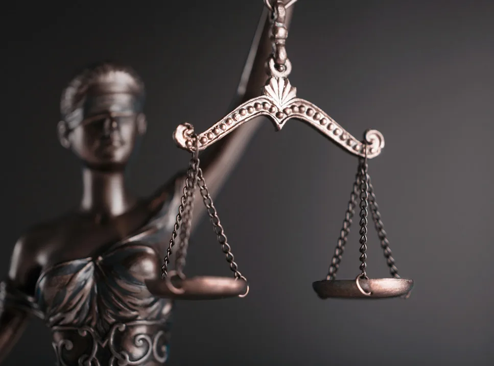 A statue of lady justice holding up the scales.