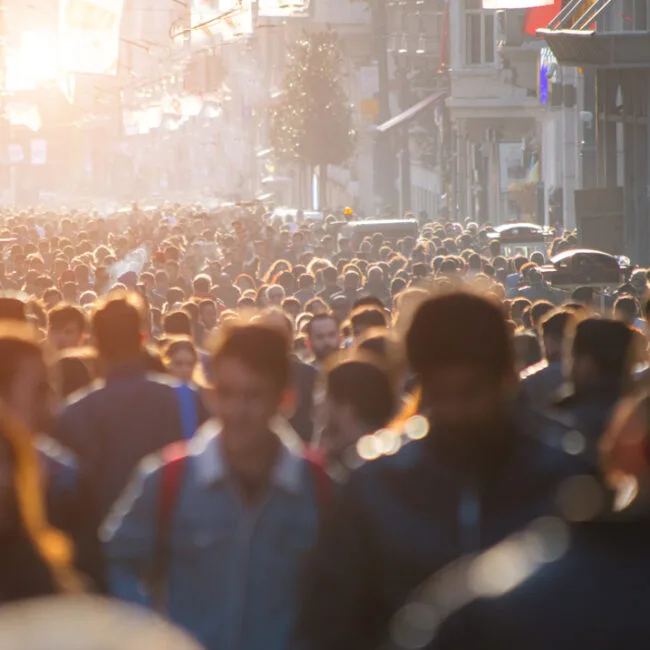 A crowd of people walking down the street.