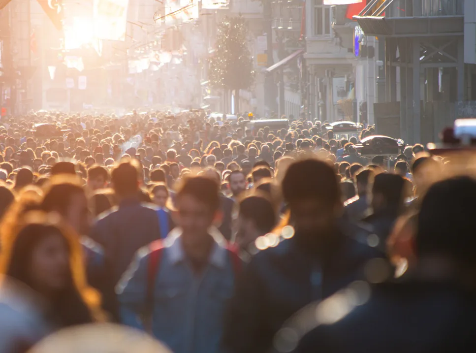 A crowd of people walking down the street.